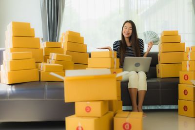 Woman sitting on sofa at home