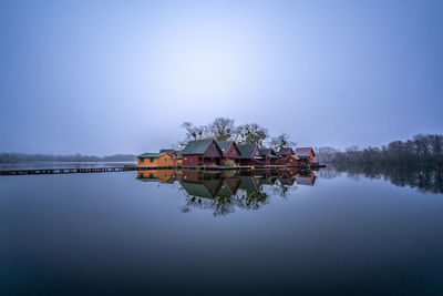 Scenic view of lake against clear sky with island 