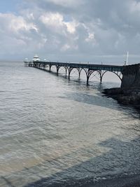 Bridge over sea against sky