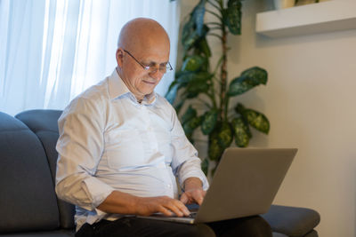 Young woman using laptop at home