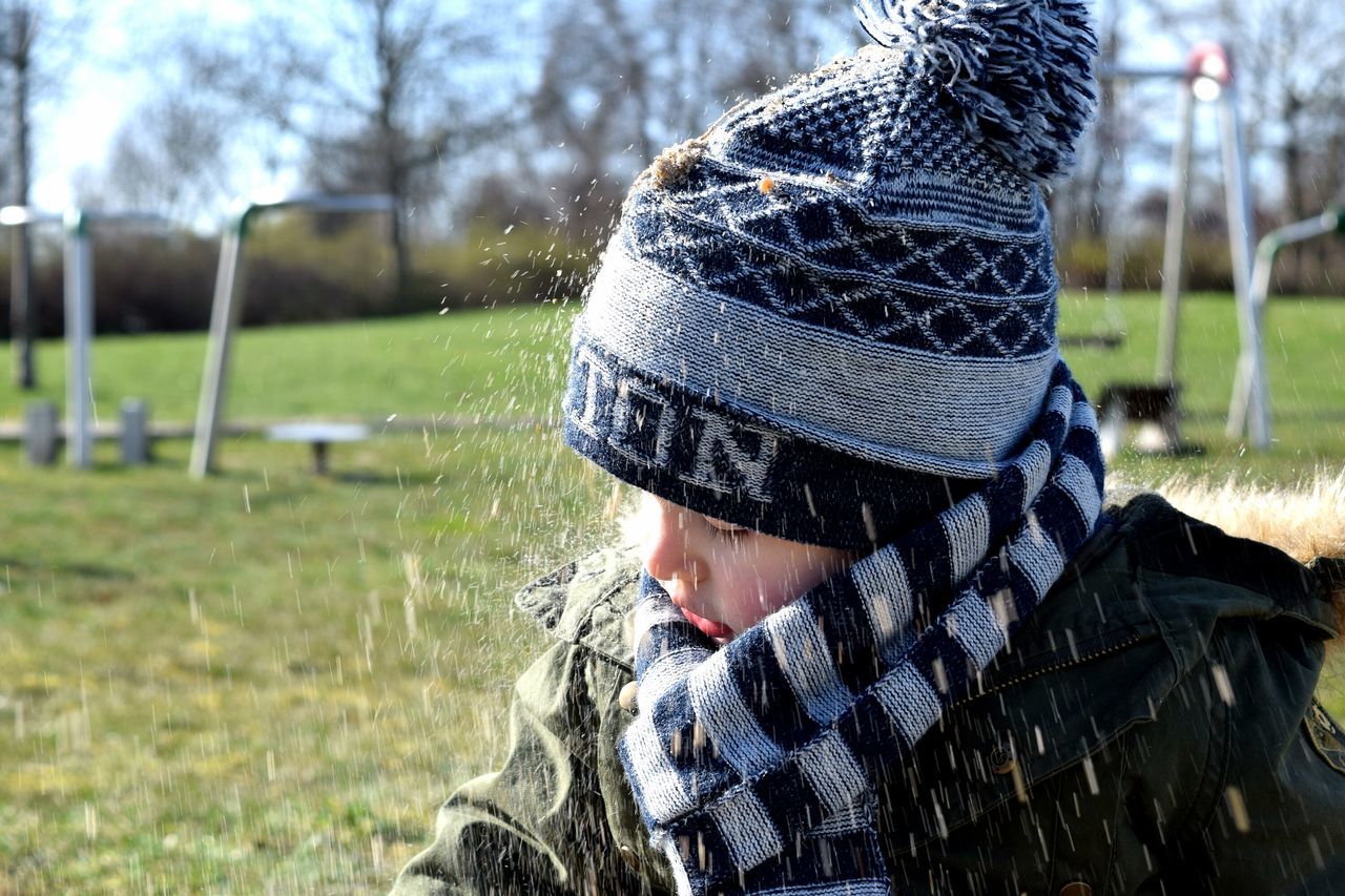 real people, one person, warm clothing, tree, headshot, leisure activity, lifestyles, knit hat, day, outdoors, grass, close-up, nature, people, adult