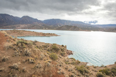 Scenic view of lake and mountains against sky