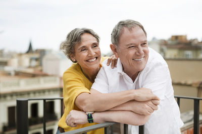 Cheerful senior couple spending quality time on terrace