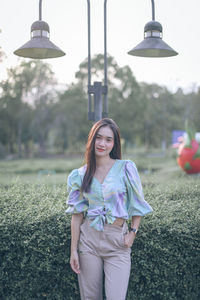 Portrait of a smiling young woman standing outdoors
