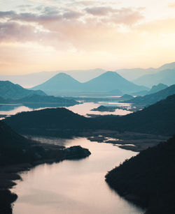 Scenic view of lake against sky during sunset