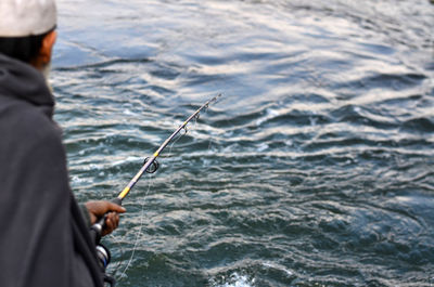 Close-up of man fishing in sea