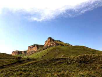 Rock formations on landscape against sky