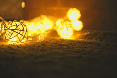 Close-up of illuminated lighting equipment on table