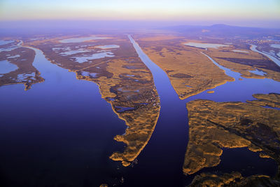 High angle view of land and sea against sky