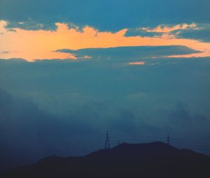 Scenic view of mountains against cloudy sky
