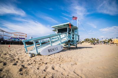 Lifeguard hut on beach against sky