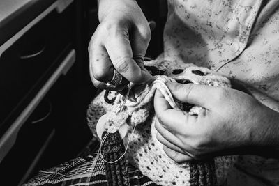 Midsection of woman knitting crochet