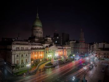 Light trail on street by national congress of argentina against sky at night