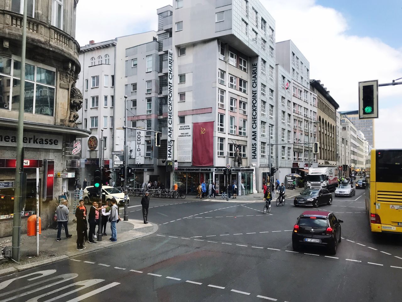 VEHICLES ON ROAD AGAINST BUILDINGS