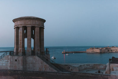 Panoramic view of sea and buildings against sky