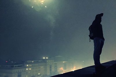 Low angle view of woman standing against sky