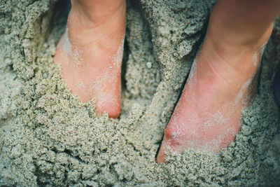 Close-up of human hand on rock