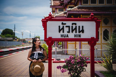 Woman with text on wall in city