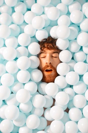 DIRECTLY ABOVE SHOT OF MAN WITH BALLOONS AT BALLOON