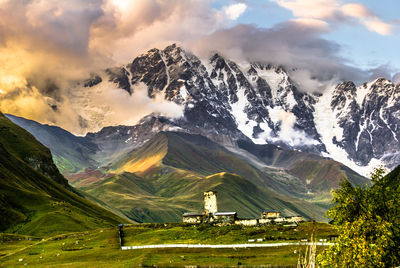 Scenic view of field and mountains against sky