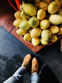 Low section of woman standing on fruit