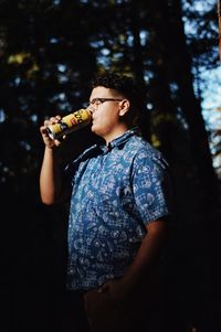 Midsection of man drinking glass