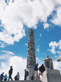 Low angle view of people against sky