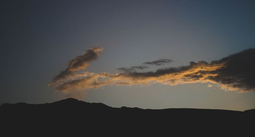 Low angle view of silhouette mountain against sky at sunset
