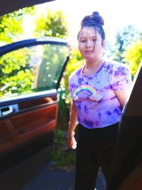 Full length of woman standing on car