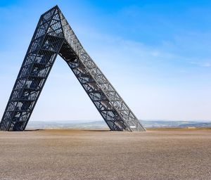 Low angle view of bridge over sea against sky