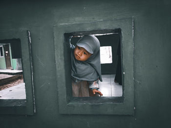 Portrait of boy in front of door