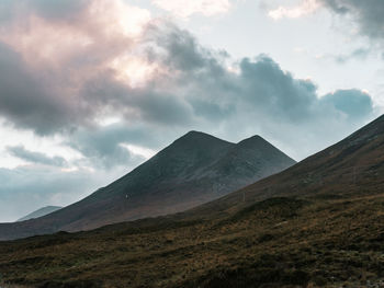 Scenic view of mountains against sky near sunset