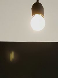 Low angle view of illuminated light bulb