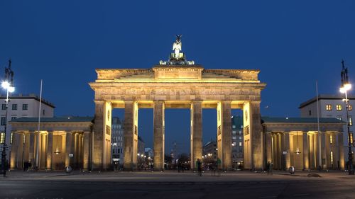 Statue in city at night