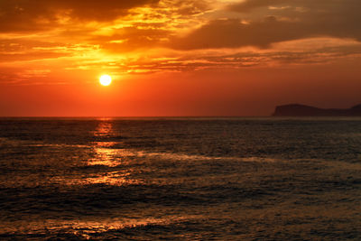 Scenic view of sea against romantic sky at sunset