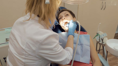 Dentist examining patient