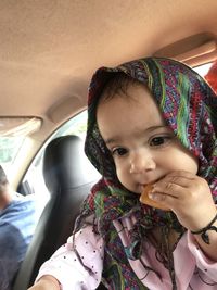 Portrait of smiling girl in car