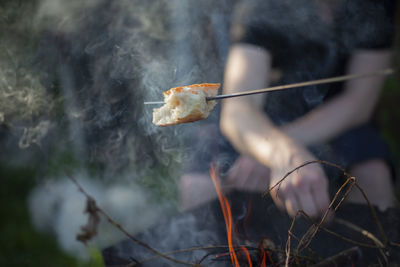 Cropped hand of woman holding dry leaf