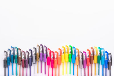 Close-up of multi colored pencils against white background