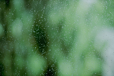 Full frame shot of raindrops on glass window