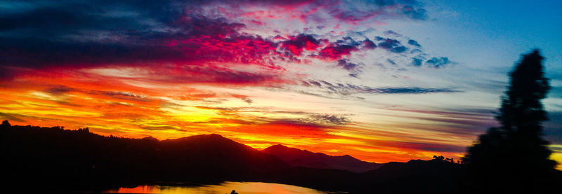 Scenic view of silhouette mountains against sky at sunset