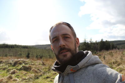 Portrait of man on field against sky