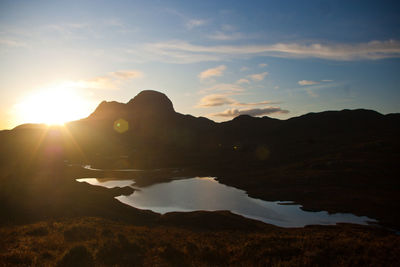 Scenic view of silhouette mountains against sky during sunset