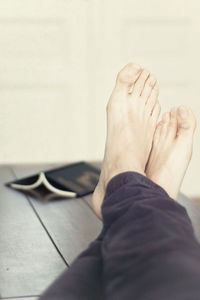 Low section of man sitting on hardwood floor