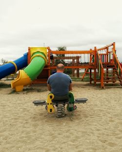 Rear view of boy sitting on seat