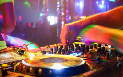 Close-up of man playing dj at nightclub