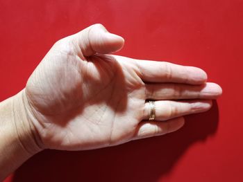 Close-up of hand on red background