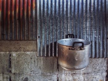 Close-up of pot hanging on wall