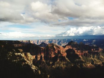 Scenic view of cliff and sea against sky