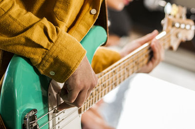 Close-up of man playing guitar